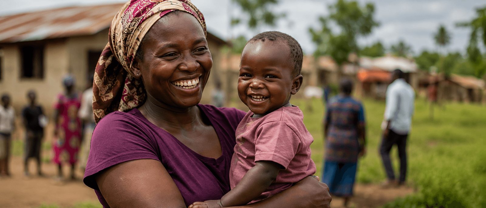 A mother smiling with her baby in a Nigerian community